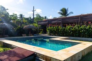 a swimming pool in the yard of a house at Pousada O Canto do Francês in Soure +61 photos