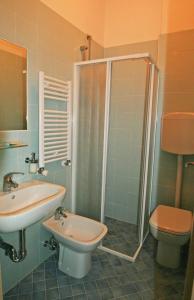 a bathroom with a shower and a sink and a toilet at acapulco hotei in Rimini