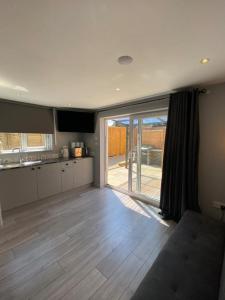 a large kitchen with a large sliding glass door at The Studios in Hempstead