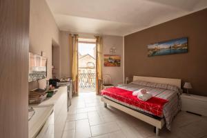 a bedroom with a bed with a stuffed animal on it at Casa Martina in Asti +7 photos