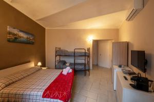 a small bedroom with a bed and a television at Casa Martina in Asti