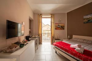 a bedroom with a bed with a red blanket at Casa Martina in Asti