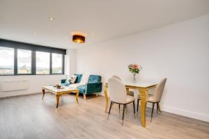 a living room with a table and chairs and a couch at ENTERPRISE APARTS in Bradford +10 photos