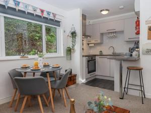 Una cocina y un comedor con mesa y sillas. en 3 Dolphin Court, en Brixham