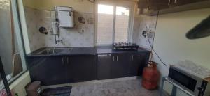 a small kitchen with a sink and a window at NHC full cottage in Nandi