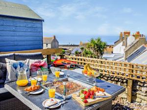 a table with food and drinks on a balcony at 2 Bed in Portland 91468 in Castletown