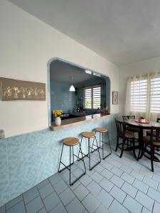 a kitchen with a table and chairs and a mirror at Villa Alborada in Arecibo