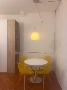 a table and chairs in a room with a light at Olivetta House Holiday in Moneglia