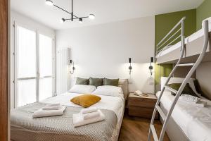 a bedroom with a bunk bed and a ladder at StayEasy Argelati40 - Penthouse with 2 bedrooms, 2 bathrooms and terrace - Navigli in Milan