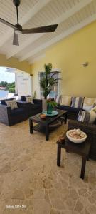 ein Wohnzimmer mit Sofas, Tischen und einer Decke in der Unterkunft Private Family Paradise Villa Ocean View With Private Pool in Kralendijk
