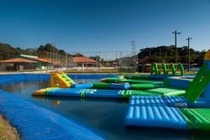 a water park with a row of inflatable slides at Pousada Paraíso do Sol in Campo Largo