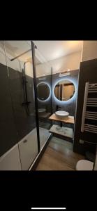 a bathroom with a shower and a toilet and a mirror at CAP ESTEREL Appartement in Agay - Saint Raphael