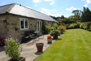 a stone house with a garden and a lawn at 2 Bed in Harrogate District HH087 in Stainburn