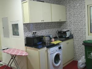 a kitchen with a washing machine and a washer at Ruby Star Hostel Dubai Couples Partition 303 in Dubai