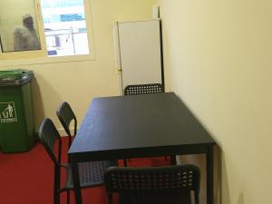 a black table and chairs in a room at Ruby Star Hostel Dubai Couples Partition 303 in Dubai