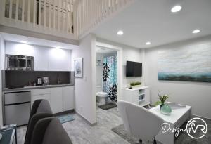 a kitchen with a living room with a couch and a table at Modern Loft wQueen Loft Steps to Beach in Hollywood +15 photos