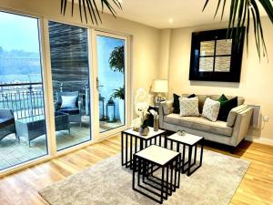 a living room with a couch and two tables at Exclusive Marina View Apartment Free Parking in Cardiff