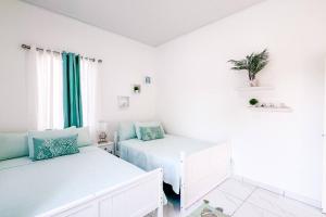 Postel nebo postele na pokoji v ubytování Atlantis Luxury Villages - Neptun