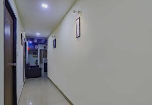 a hallway in a hospital with two pictures on the wall at Collection O Greenwood in Ahmedabad