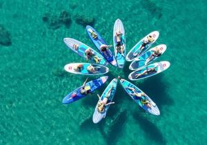 a group of people on surfboards in the water at Stegna Sunny-Beach in Archangelos