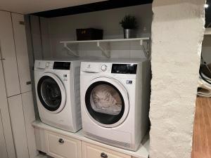 a dryer and a washing machine in a kitchen at Villa Amare in Uddevalla