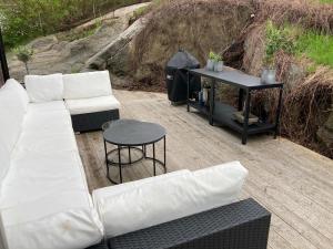 a living room with a white couch and a table at Villa Amare in Uddevalla