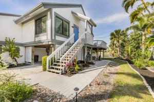 a home with a white house with palm trees at A Peace Of Heaven in Sanibel