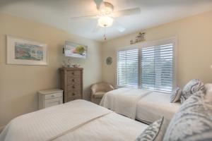 a bedroom with two beds and a window at A Peace Of Heaven in Sanibel