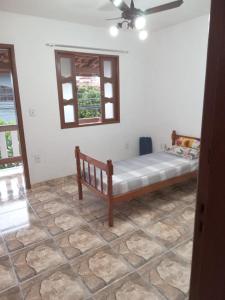 a bedroom with a bed and a window at Pousada do vovô in Rio das Ostras