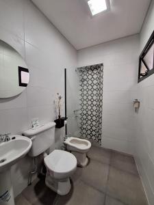 a white bathroom with a toilet and a sink at OSTATUA ETXEA in Salta