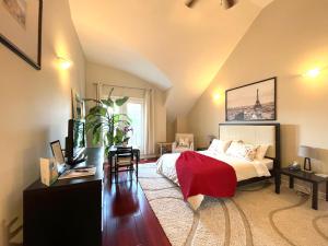 a bedroom with a bed and a dresser and a table at Stunning Rooms in Townhouse across the Beach in Toronto