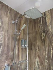 a shower with a shower head in a bathroom at Sgurr Alasdair B&B in Portree