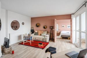 a living room with a couch and a table at Apartment with fantastic views in Pantin - Welkeys in Pantin