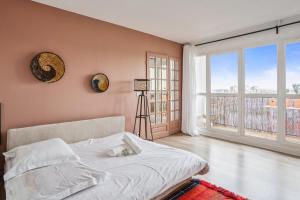 a bedroom with a bed with a cat laying on it at Apartment with fantastic views in Pantin - Welkeys in Pantin