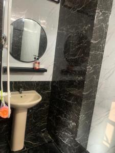 a bathroom with a sink and a mirror at Hanna homestay studio in Alor Setar