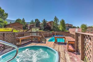 a hot tub on a deck with a table at Mtn-View Condo about 3 Mi to Dtwn Steamboat Springs! in Steamboat Springs