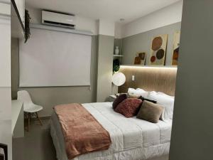 a bedroom with a bed and a table with a chair at Studio 1111 in Rio de Janeiro