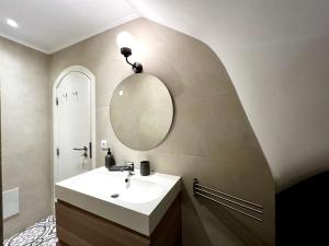 a bathroom with a sink and a mirror at Cozy apartment with terrace in Cascais in Aldeia de Juso