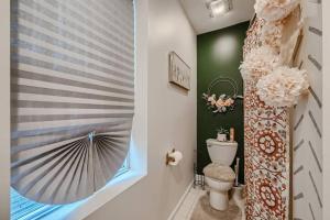 a bathroom with a toilet and a window at Baltimore Beauty! Johns Hopkins! 3 bedroom apt in Baltimore
