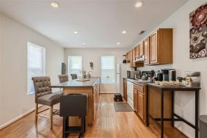 a kitchen with wooden cabinets and a counter top at Baltimore Beauty! Johns Hopkins! 3 bedroom apt in Baltimore
