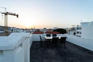 a table and chairs on the roof of a building at be Unforgettable Apartment in Faro
