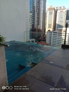 a swimming pool on the roof of a building at 1ceylon pharoh studio in Kuala Lumpur