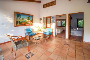 a living room with blue chairs and a coffee table at Casa Cumbres Ecolodge in Yopal
