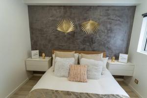 a bedroom with a white bed with two night stands at be Unforgettable Apartment in Faro