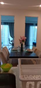 a dining room with a table with chairs and flowers at 1ceylon pharoh studio in Kuala Lumpur