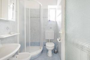 a bathroom with a toilet and a sink and a shower at CREUZA DE 5 TERRE in Volastra