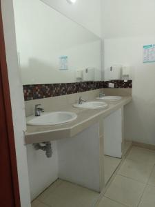 a bathroom with three sinks and a mirror at Luka Cartagena Hotel in Cartagena de Indias