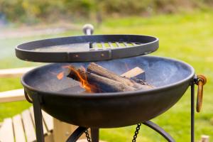 a grill with a bunch of fire in it at Lazy Lodge in Redruth