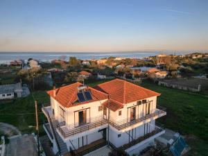 an aerial view of a house with an orange roof at Ocean Breeze Apartment in Kypseli