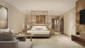 a bedroom with a bed and a living room at Grand Velas Boutique Hotel in San José del Cabo